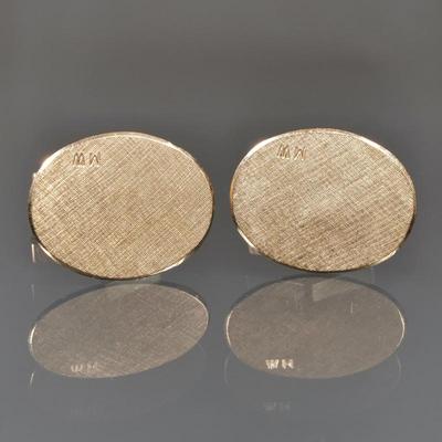 14K GOLD CUFFLINKS WITH MONOGRAM | A pair of oval, matte yellow gold cuff links, with small 'M.W.' monogram, with fineness mark...