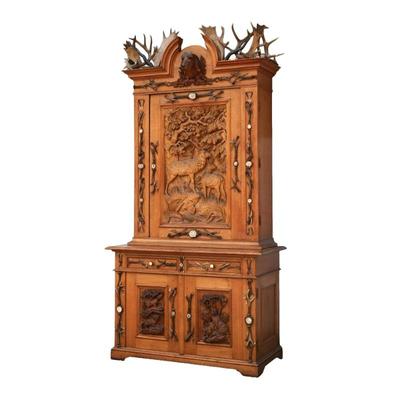 BLACK FOREST CARVED HUNT CABINET | 20th century, crested with a carved dogs head
h. 106 x w. 56 x d. 26 in. (excl. crest [13 in.])