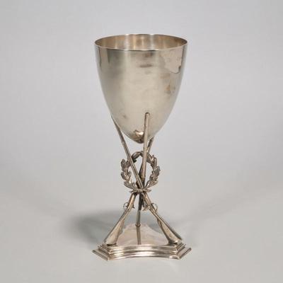 EARLY ENGLISH STERLING CROSSED RIFLES HUNTING TROPHY | Designed as a tapering goblet form vessel raised a tripod base in the form of...
