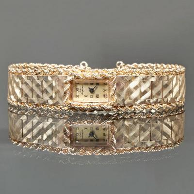 JULES JORGENSEN 14K GOLD LADY'S WATCH BRACELET | Flexible, textured 14k yellow gold watch band, with twisted rope chain details on...