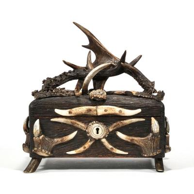 ANTIQUE BLACK FOREST ANTLER DECORATED BOX |19th century, the carved wooden box with applied antler decoration, raised on antler feet
h....