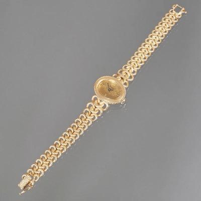BENAT LADY'S 14K GOLD WRISTWATCH | Lady's wrist watch designed as a gold bracelet with interlocking links and having an oval...