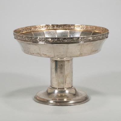 A FINE GERMAN ART NOUVEAU 800 SILVER CENTERPIECE | Having a faceted bowl with repousse rim of viney floral decoratio;ns, raised on a...