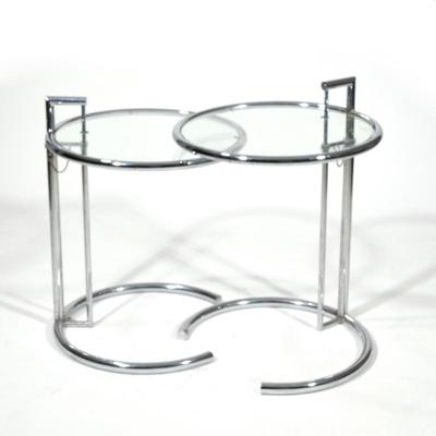 (2pc) PAIR EILEEN GRAY CHROME CHROME & GLASS TABLES | Pair of circular adjustable chrome & glass side tables
h. 27 x dia. 20.25...