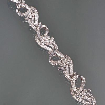 DIAMOND & 14K WHITE GOLD RIBBON FORM BRACELET | Designed as 6 white gold & diamond hinged stations, each station having diamond...