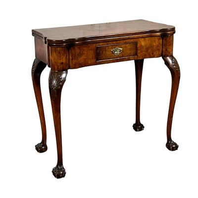 A GEORGE II INLAID GAMES TABLE | Having burlwood veneer with felt lined flip-top with dish corners, over single drawer, raised on...