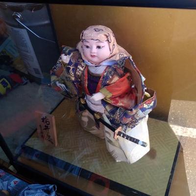 Large asain doll in glass showcase