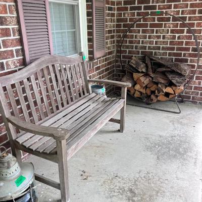 Wood bench and round metal firewood holder