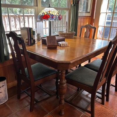 Solid wood stretcher base table. 4 chairs. 