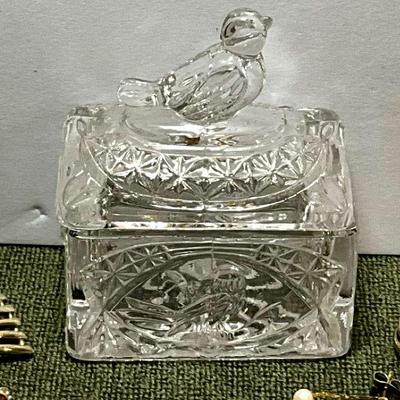Glass lidded trinket box with gold tone earrings