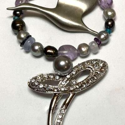 Silver tone jewelry pins a bracelet