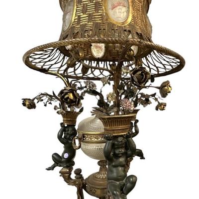 Sale Photo Thumbnail #155: Incredible Antique Continental Torchere in the French Empire Style. Bronze Base. Top with 3 cherubs / putti with tole accents support a shade with intricate basket weave design and floral glass cameo medallions. Converted from a oil or brazier lamp to ele
