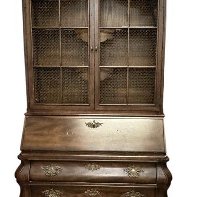 Sale Photo Thumbnail #144: A French Country style slant front secretary desk by Henredon, from their Four Centuries collection. Solid oak, brass hardware and wire mesh. The upper cabinet features decoratively carved top, two fixed wood shelves behind wire mesh doors and wire mesh s