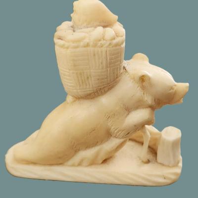 Sale Photo Thumbnail #48: Hand Carved Alaskan Walrus Fossil Ivory Bear carrying a basket with a child. Measures 3 1/2" long. and 3 1/4" tall. Weight 3.4 oz. PROVENANCE: A Private Charleston SC Estate. This Walrus Ivory is Alaskan native collected and carved. It is a natural materi