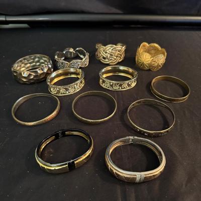 Lot 240: Gold Tone And Rubbed Brass Cuffs And Bengals