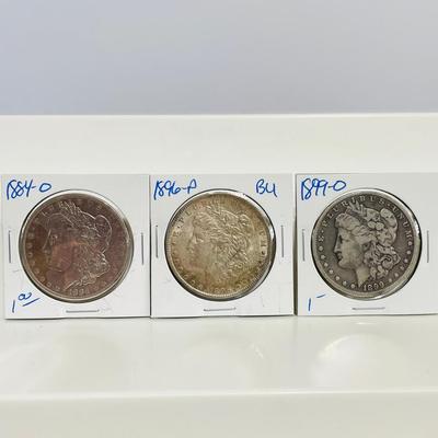 16) Three Morgan Dollars 1884-O, 1896-P, 1899-O