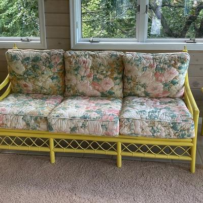 Yellow Patio Couch With Floral Cushions And Two Matching Side Tables