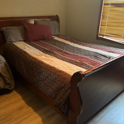 Brown full-sized wooden bed with dresser