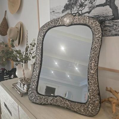 Silver repousse mirror with blue velvet
