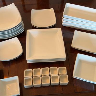 Collection Of White Ceramic Dishes And Serving Pieces