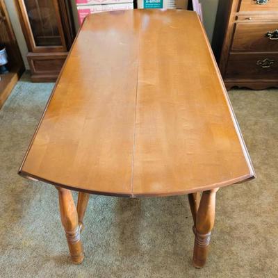 Solid wood table with two folding leaves