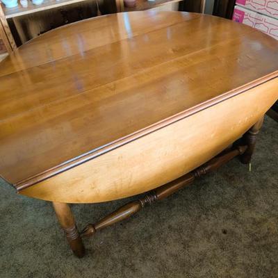 Solid wood table with two folding leaves