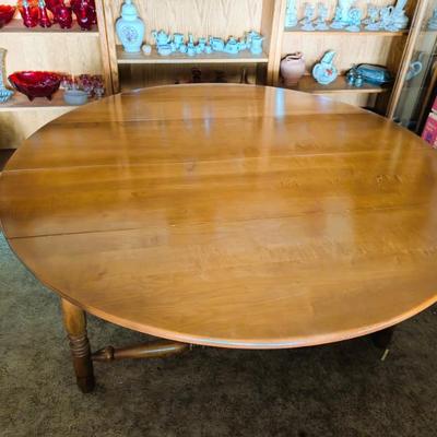Solid wood table with two folding leaves