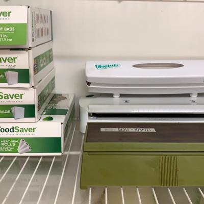 Two Food Saver Vacuum Sealers Plus Wax Paper Storage/cutter