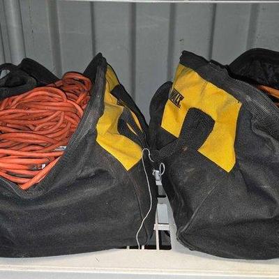 8142 • (2) dewalt tool bags filled with extension cords & skilsaw