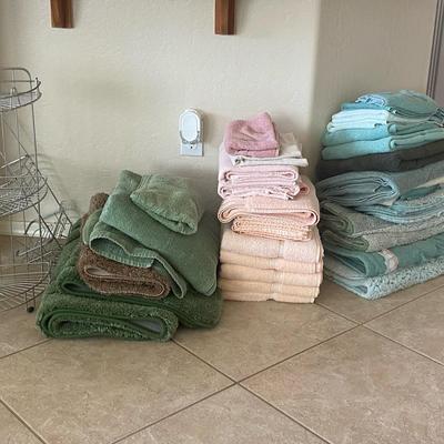 Assortment Of Bath And Hand Towels With Shower Storage