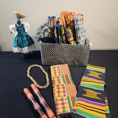 Doll, basket of fabric, candle sticks, glass bead necklace, mantles