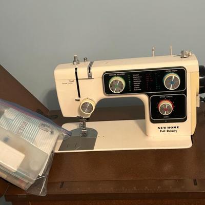 Sale Photo Thumbnail #1: Cabinet sewing machine including attachments and manual