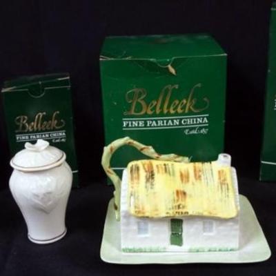 Sale Photo Thumbnail #23: 1023	IRISH BELLEEK ASSORTMENT INCLUDING 2 COVERED JARS, FIGURE *THE WARE CARRIER* AND CHEESE DISH, LARGEST PIECE APPROXIMATELY 6 1/2 IN H
