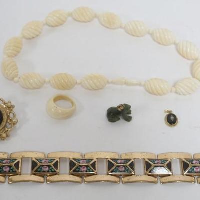 Sale Photo Thumbnail #208: 1206	JEWELRY ASSORTMENT INCLUDING ONYX PENDANT MARKED CARLA 14K/20 WEIGHING .58 DWT WITH STONES, CAMEO PIN, JADE FROG PENDANT, PAINTED BRACELET, NECLACE AND RING
