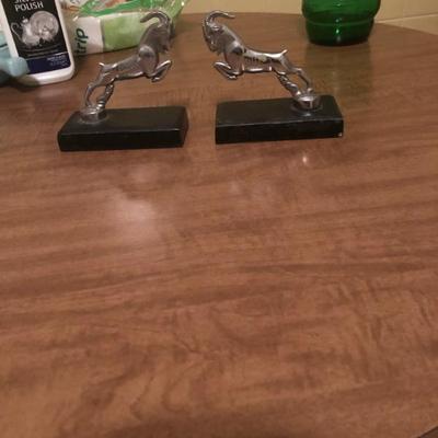Mid-century modern bookends, chrome rams atop heavy stone bases
