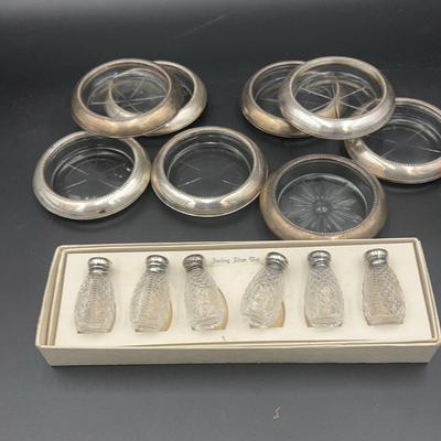 Eight sterling silver and glass coasters: six salt and pepper shakers