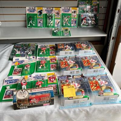 Starting Lineup Football Figurines Including Joe Montana, Peyton Manning, And Deion Sanders