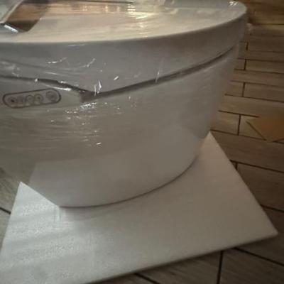 The toilet has a warming seat and it actually puts the lid down for you