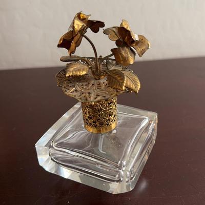 Vintage Perfume Bottle with Gold Flower Accents.  Stands on a base.