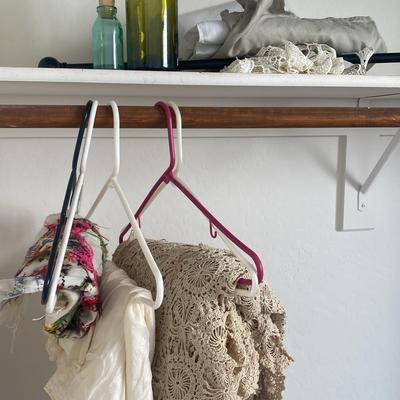 Small Curtain Rod With Woven Cream Curtain With Collectible Bottles And Assortments Of Doilies