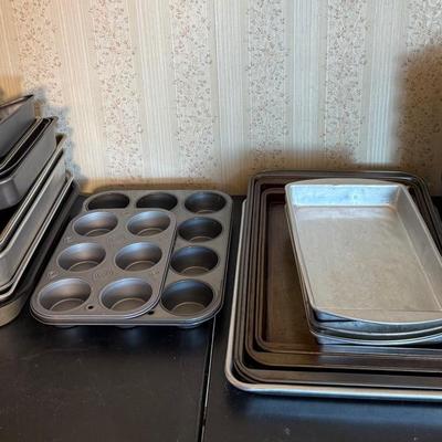 A Large Assortment Of Aluminum Baking Pans And Sheets