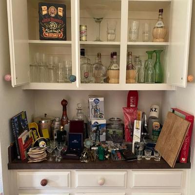 large assortment of bar items from openers to decanters