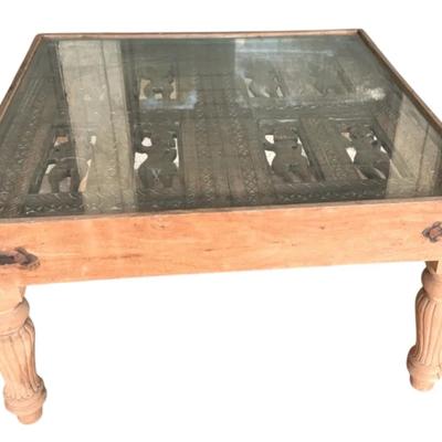 Very unique hand carved wooden table with glass overlay