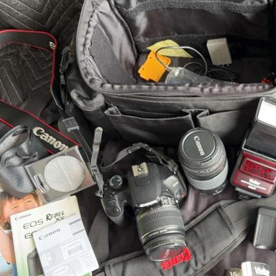 Canon EOS DSLR kit, Canon lenses (75–300mm telephoto, 35–80mm standard zoom,), charger, bag.