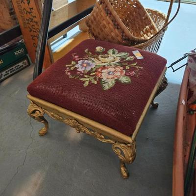 Several small needle point footstools
