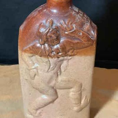 A stoneware jim crow' gin flask exact age unknown
