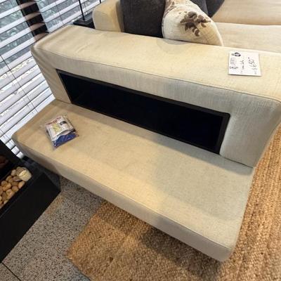 Unique off-white sofa with a built-in storage unit—like having a sofa table perfectly integrated