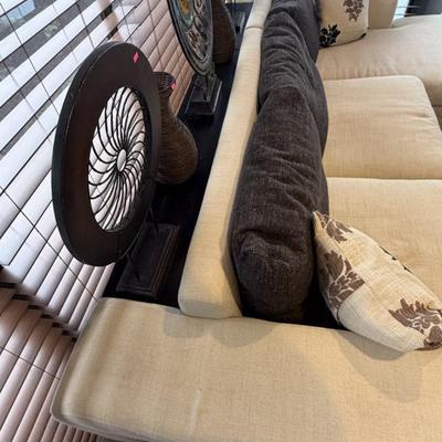 Unique off-white sofa with a built-in storage unit—like having a sofa table perfectly integrated