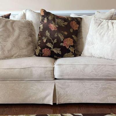 Ivory Upholstered Sofa with Floral Accent Pillows