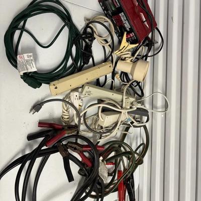 Set Of Extension Cords, Jumper Cables, And Car Battery Charger 